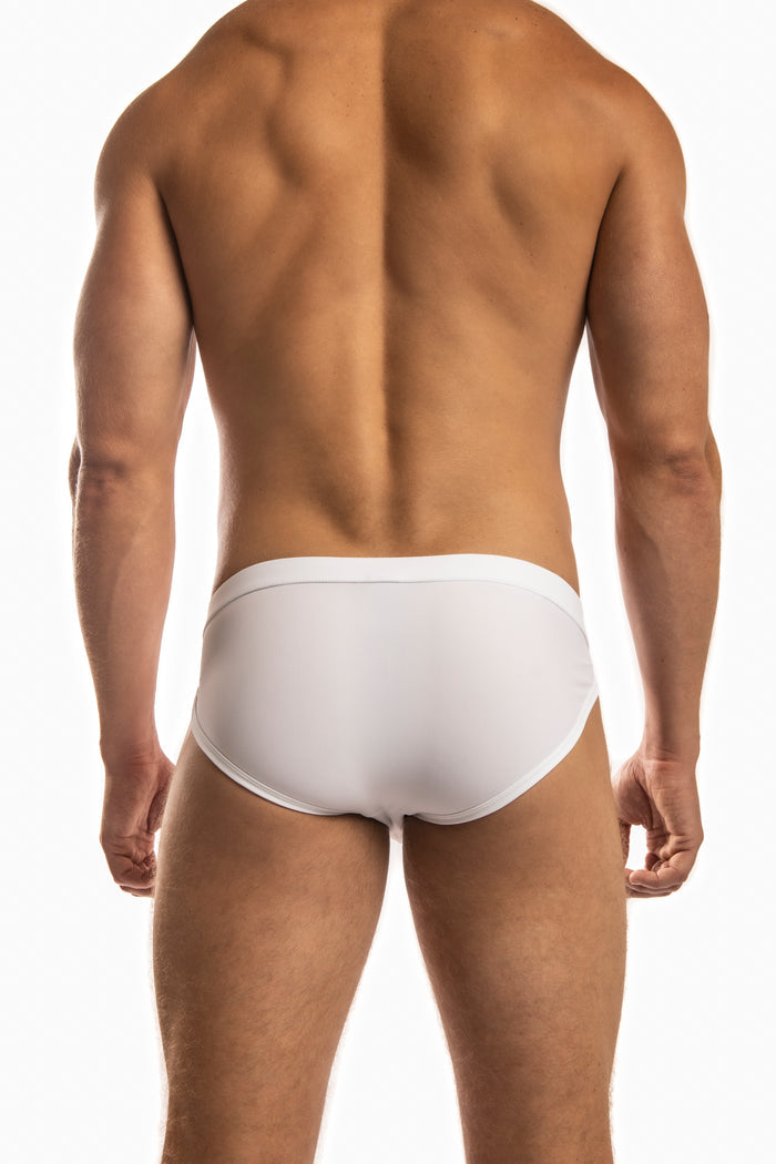 Man wearing a pair of Jack Adams white Apollo Swim Briefs (back view) standing before a white background.