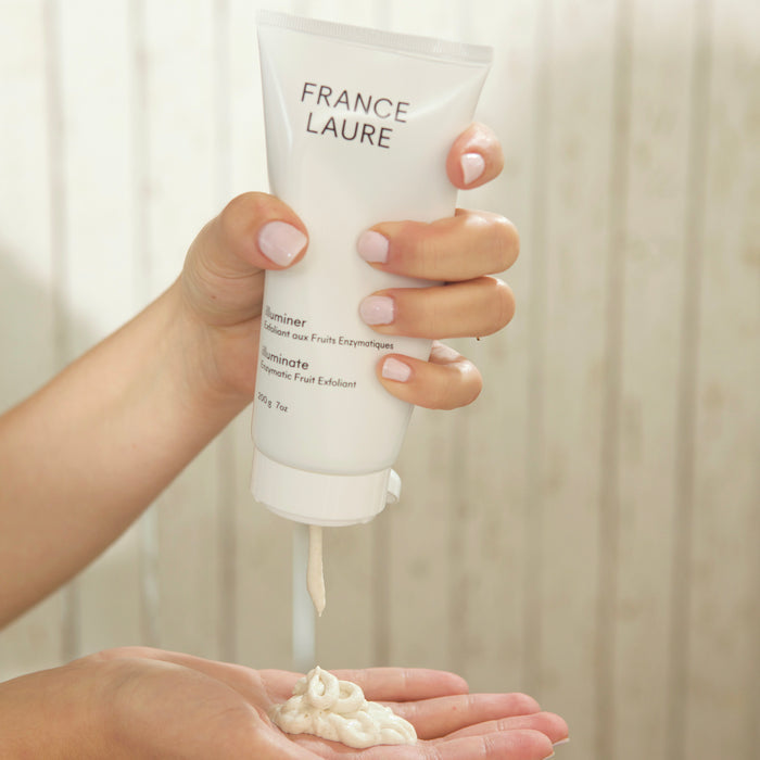 France Laure Illuminate Enzymatic Fruit Exfoliant being squeezed onto hand, gentle facial scrub for all skin types