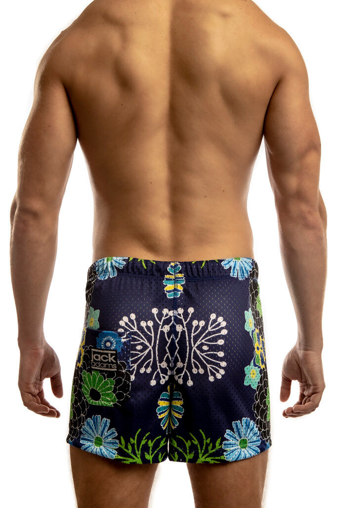 Man standing wearing a pair of Jack Adams japanese flower- royal Freestyle Mesh Shorts (back view) on a white