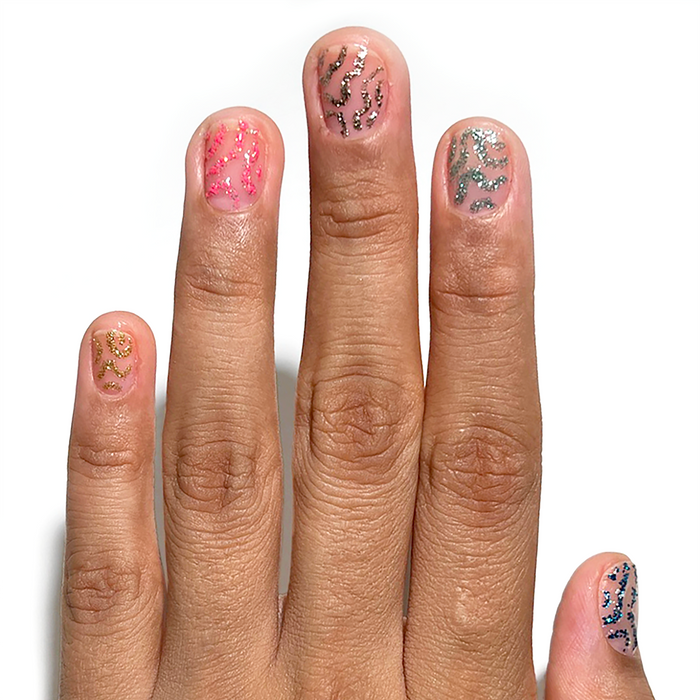 Gold Leaf and glitter liners used for abstract accent nail art on a medium skin tone