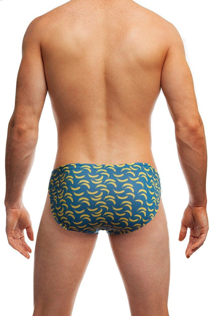 Man standing wearing a pair of Jack Adams indigo IT's Bananas Swim Brief (back view) on a white background.