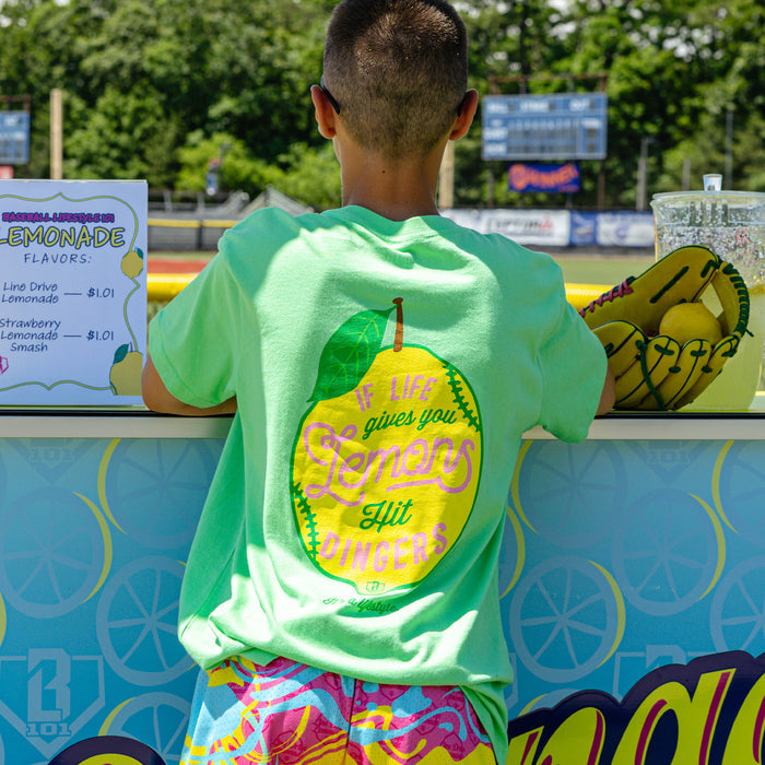 Youth model wearing green youth graphic tee with "Lemon Dingers" design