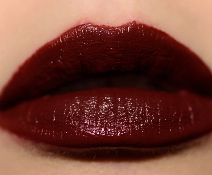 M.A.C Love Me Liquid Lipcolour in four shades, featuring close-up of lips wearing various vibrant lipstick colors.