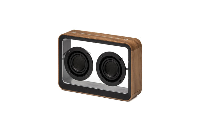 Walnut see-through speaker with two black drivers in a clear front panel