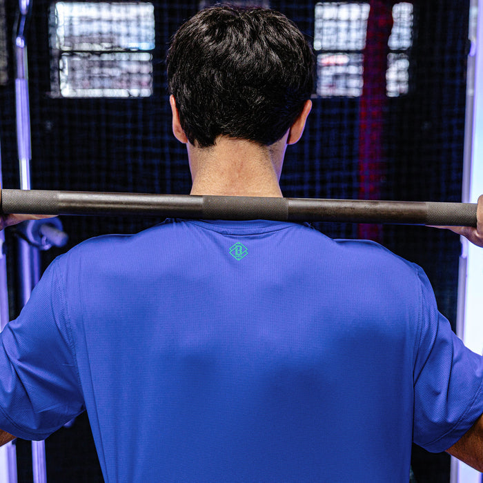Person lifting a barbell in a gym setting