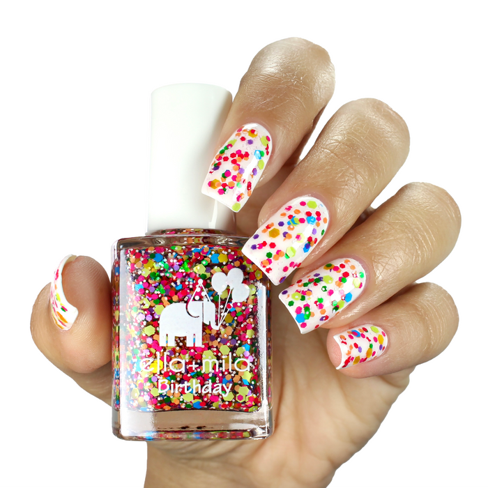 Ninth Street colorful confetti nail polish manicure on a light skin tone with the bottle