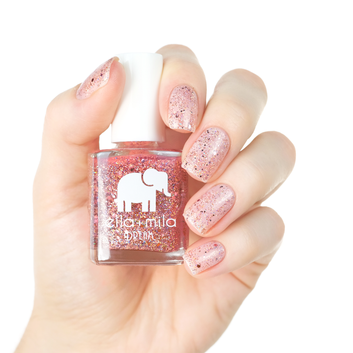 After Party rose gold glitter nail polish manicure on a light skin tone with the bottle