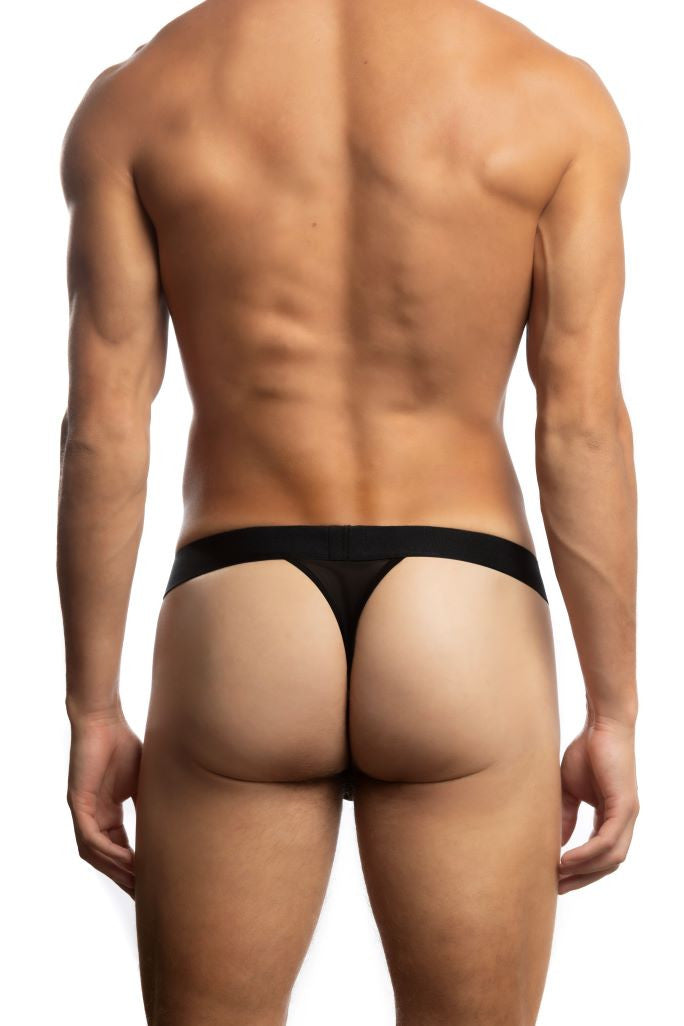 Shirtless man standing in front of a white background wearing a pair of Jack Adams All Over Mesh Thong in black (back view)