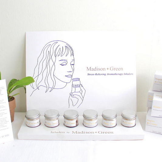 Aromatherapy inhaler sampler display with multiple small glass jars and boxes