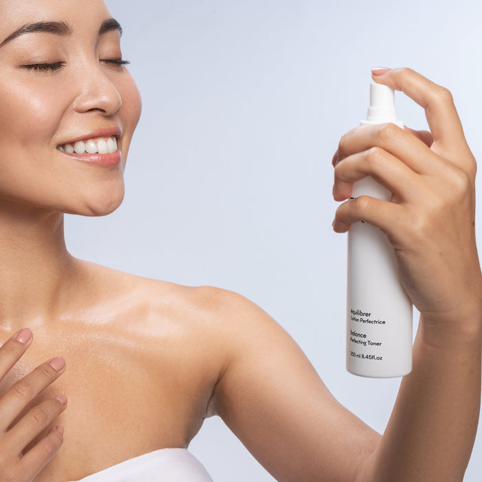 Woman applying Balance Perfecting Toner spray for radiant, hydrated skin—ideal for all skin types and ages.