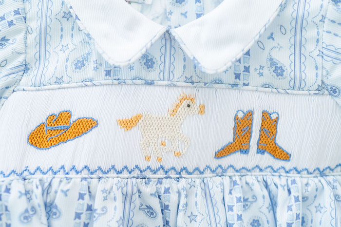 With its timeless smocked accents, this blue western bubble is ideal for special occasions or everyday wear.