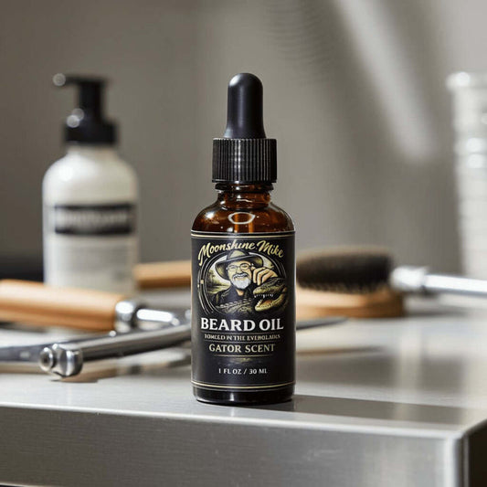 Fort Denaud Beard and Skin Gator Scent beard oil in a 1oz amber glass dropper bottle on a stainless steel surface.