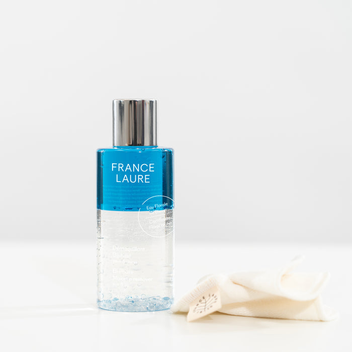 France Laure bi-phase eye & lip makeup remover with cornflower floral water, shown with a soft cleansing cloth on white background