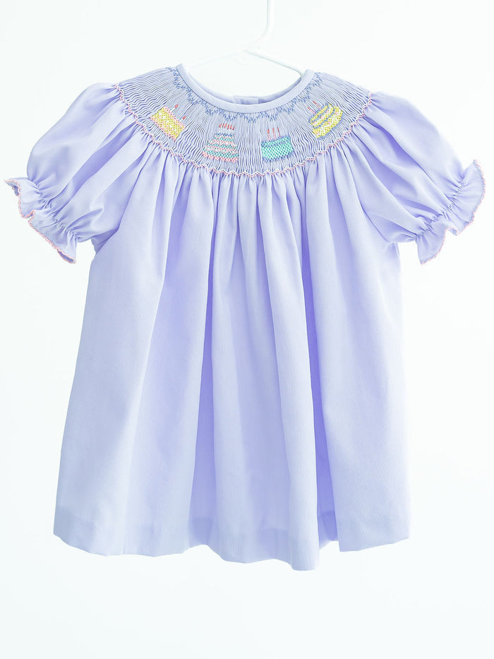 Birthday Girl Helen Dress is a precious dress featuring birthday cake designs on a super soft and comfortable polyester/cotton blend. Perfect for celebrating her special day, this charming ensemble adds a touch of sweetness to her birthday festivities, it comes in sizes for toddlers 2T to 6.