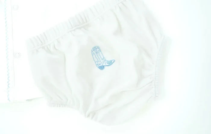 Close up of hand embroidery blue cowboy boot on baby layette set.