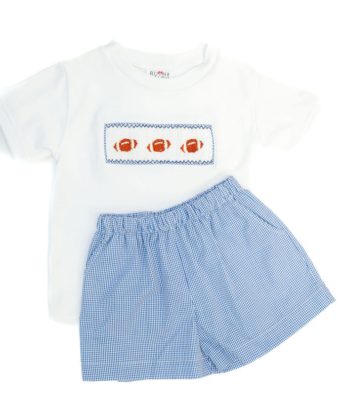 Boy's two-piece game day set featuring a hand-smocked football panel and classic blue gingham shorts