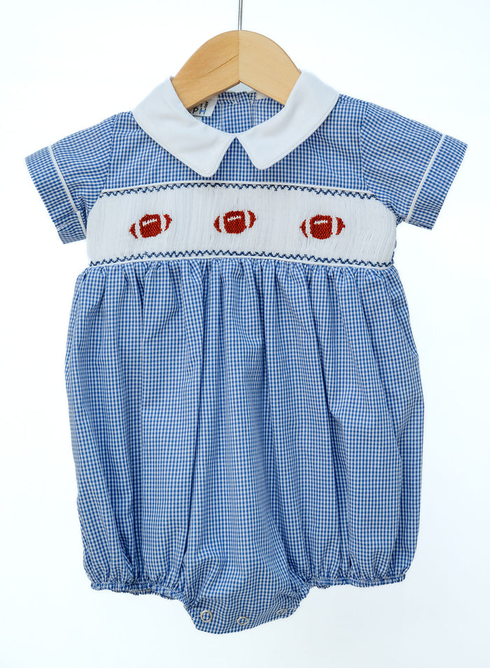 Smocked Football Bubble in blue gingham with a hand-smocked panel of three footballs and a collared neckline