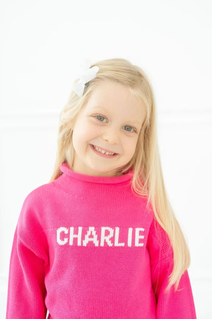 A young girl wearing a Pink Personalized Sweater - Custom Knit