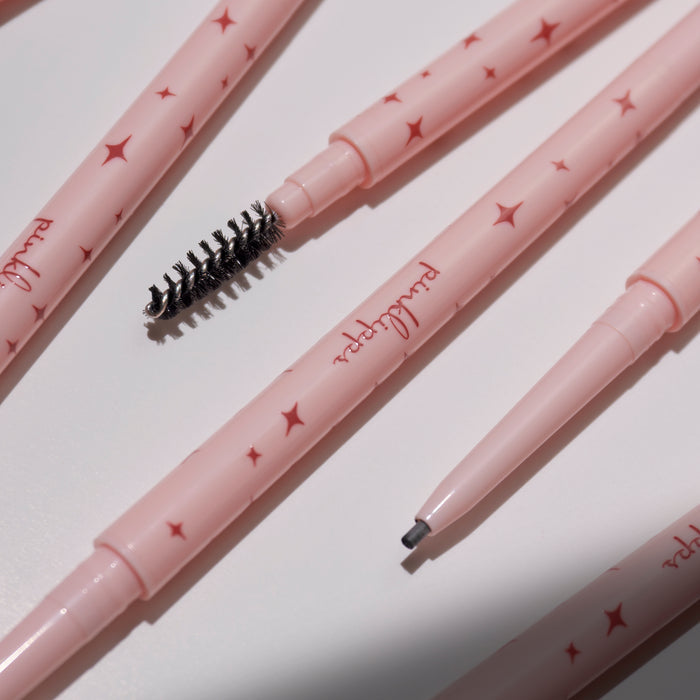 Flat-lay of Brow’d Up Brow Pencil set with precision tip and spoolie, editorial styling, brand message: Confidence is Beauty.