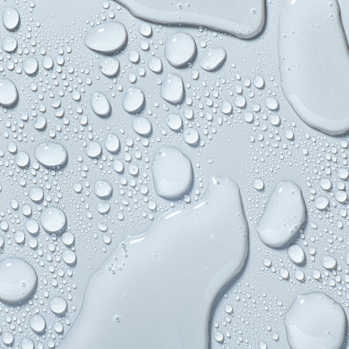 Close-up of hydrating skincare essence with glistening water droplets and dewy texture for all skin types