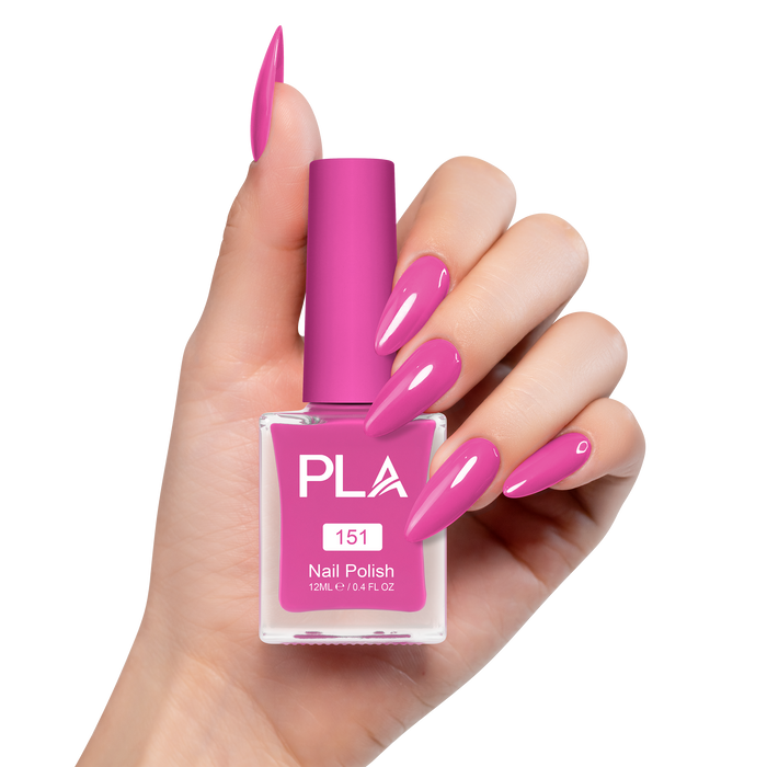Hand holding a pink nail polish bottle with matching nails on a white background