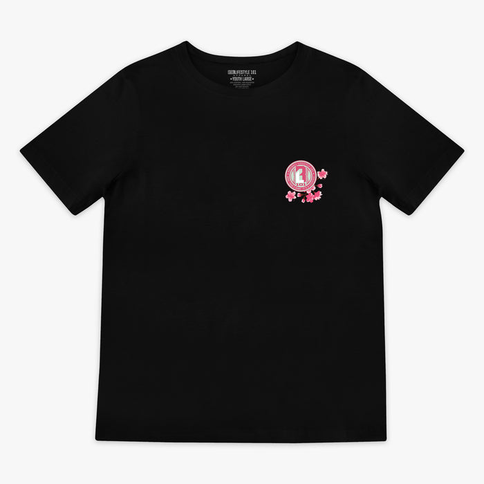 Front of black BL101 tee with a pink cherry blossom BL101 seal logo on the left chest, flat lay view
