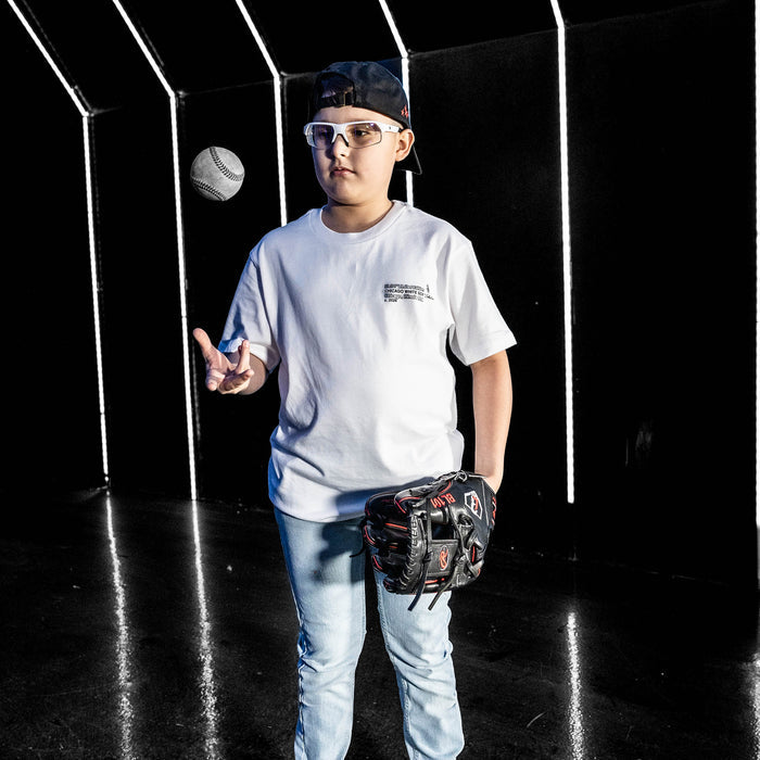 Youth model wearing white youth graphic tee with "Chicago White Sox Drip" design