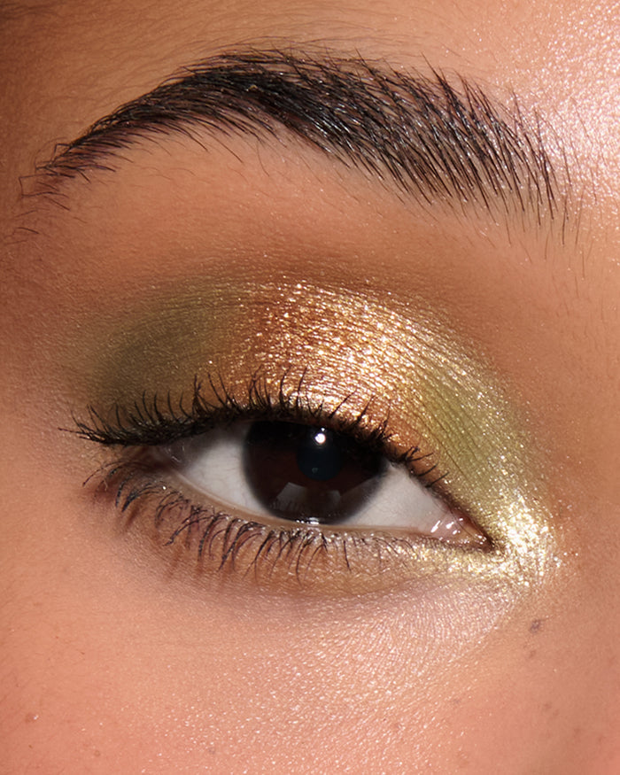 Extreme close-up of an eye with khaki, orangey champagne eyeshadow from Desert Gleam Eyeshadow Palette