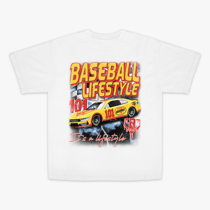 Flat lay front of white vintage relaxed tee with yellow and red Baseball Lifestyle 101 race car graphic, checkered flag, and "It's a Lifestyle" script.