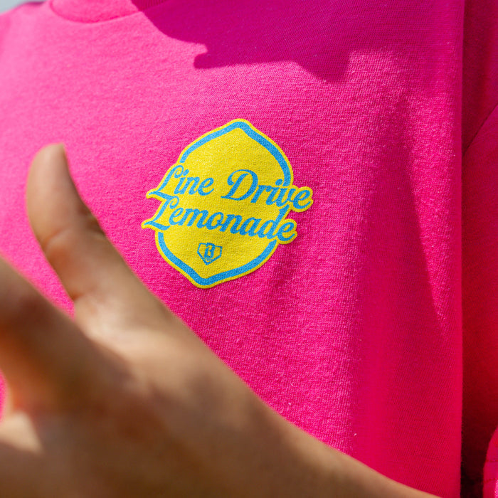 Youth model wearing pink youth graphic tee with "Electric Lemonade" design