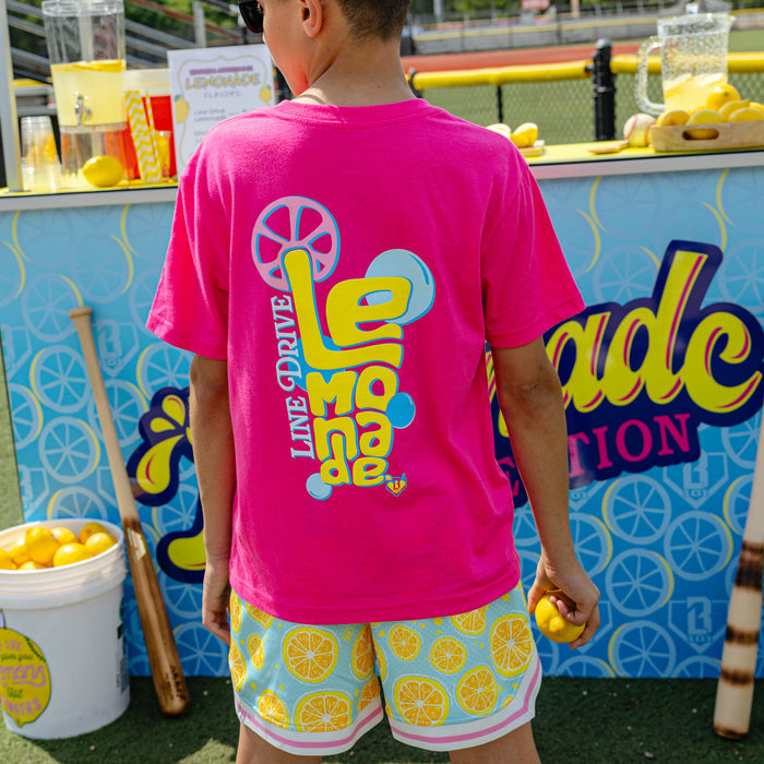 Youth model wearing pink youth graphic tee with "Electric Lemonade" design