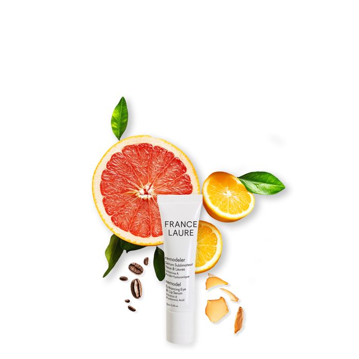 France Laure Remodel Enhancing Eye & Lip Serum with Vitamin A and Hyaluronic Acid, surrounded by grapefruit, orange slices, coffee beans, and ginger
