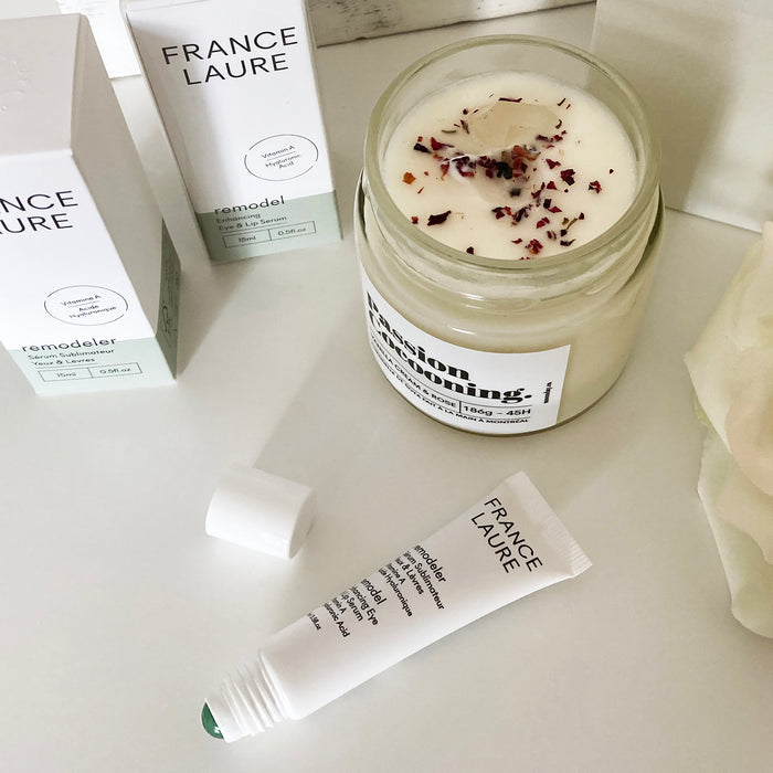 France Laure skincare collection featuring remodeler eye & lip serum, vanilla rose candle with dried petals, and product packaging on white surface
