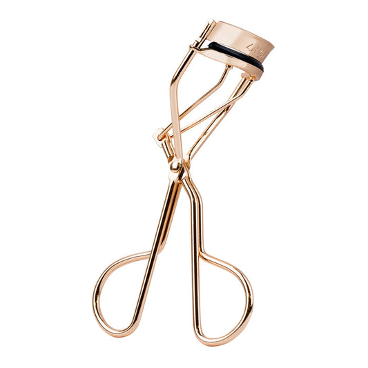 Rose gold eyelash curler on a white background