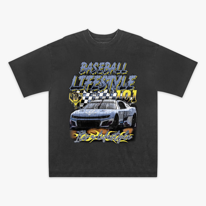 Flat lay of washed black vintage relaxed tee with full-front Baseball Lifestyle 101 race car graphic, checkered flag, and "It's a Lifestyle" flame script.