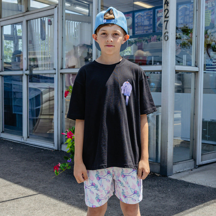 Youth model wearing black Fastball Scoops youth graphic tee