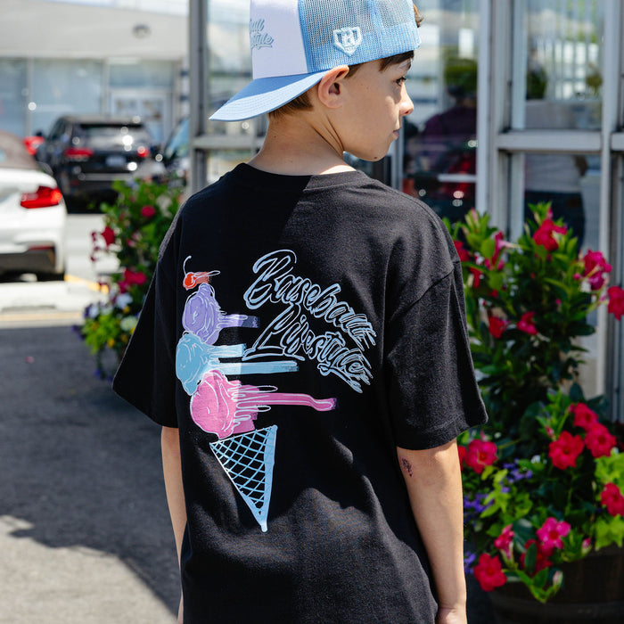 Youth model wearing black Fastball Scoops youth graphic tee