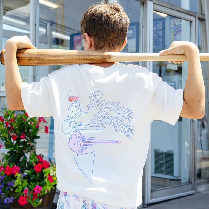 Youth model wearing cream Fastball Scoops youth graphic tee