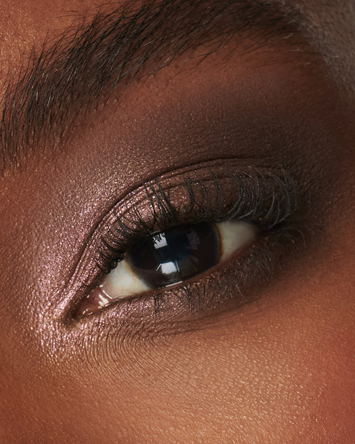 Extreme close-up of an eye with pink and brown eyeshadow from Fawn Eyeshadow Palette