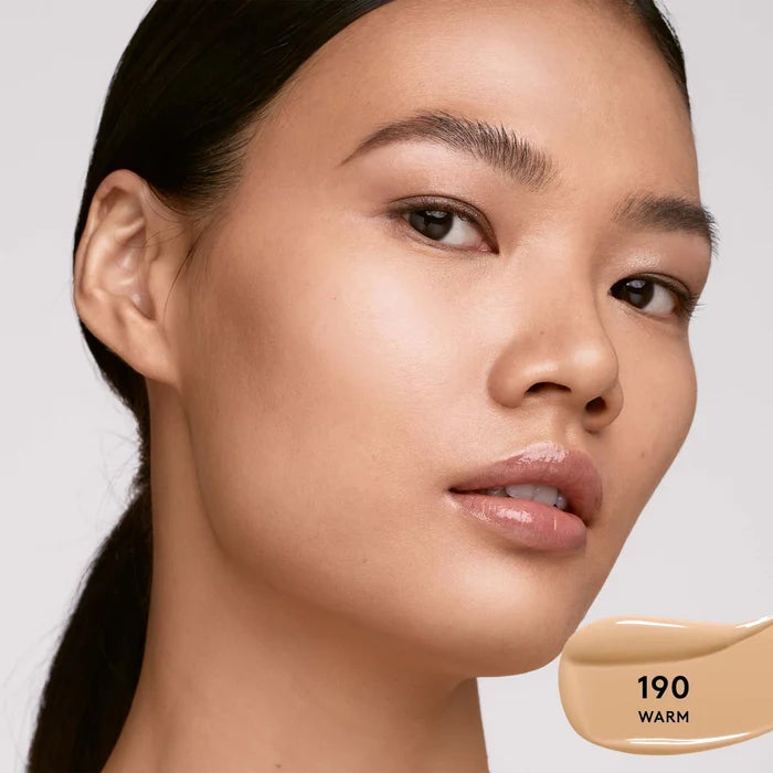 Fenty Beauty Soft’Lit Hydrating Longwear Foundation in various shades, featuring a sleek bottle with a pump dispenser.