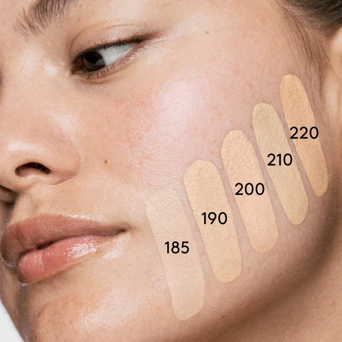 Fenty Beauty Soft’Lit Hydrating Longwear Foundation in various shades, showing a close-up of the creamy liquid foundation in a beauty product jar.