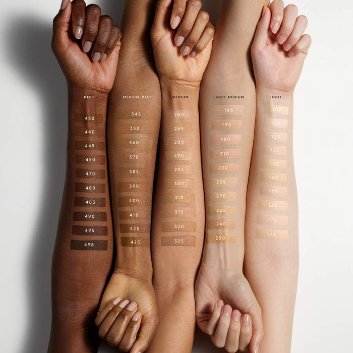 Fenty Beauty Soft’Lit Naturally Luminous Hydrating Longwear Foundation in various shades, display of the bottle with product label