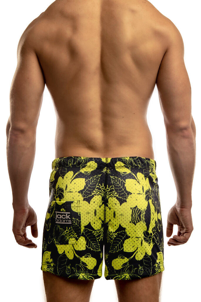 Man standing wearing a pair of Jack Adams hibiscus royal-yellow Freestyle Mesh Shorts (back view) on a white