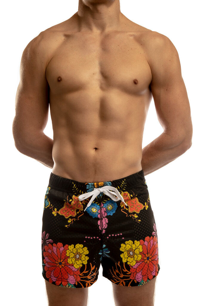 Man standing wearing a pair of Jack Adams japanese flower-  black Freestyle Mesh Shorts (front view) on a white