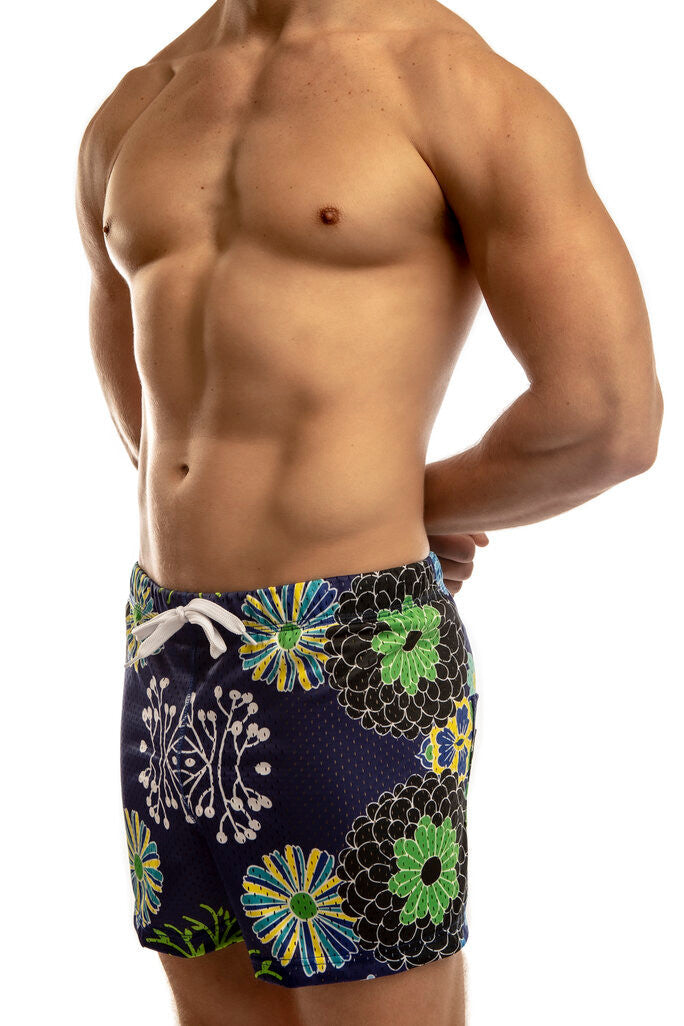 Man standing wearing a pair of Jack Adams japanese flower-  royal Freestyle Mesh Shorts (profile view) on a white