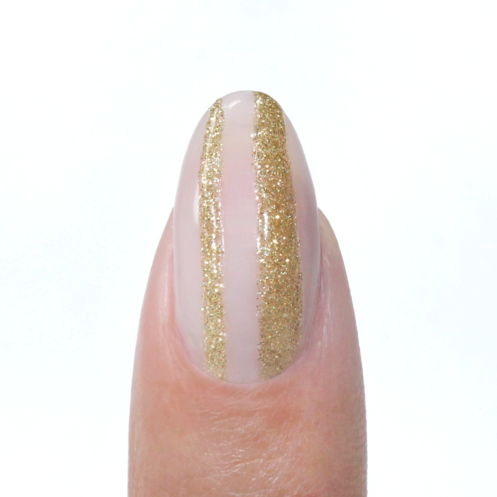 Gold Leaf liner used for a gold glitter vertical stripe on a sheer nude nail