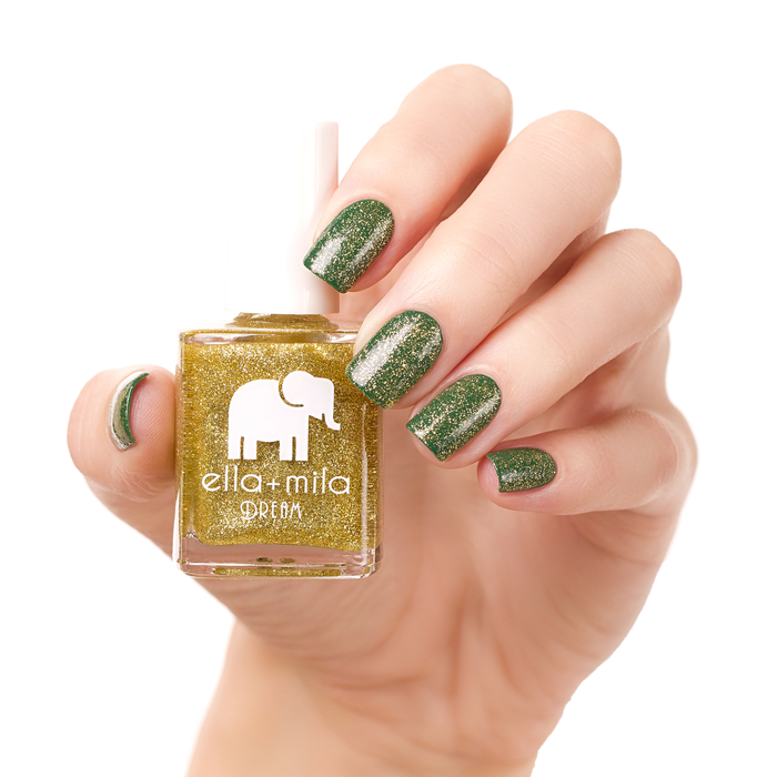 Golden Fairy gold glitter nail polish alternating with dark green on a light skin tone