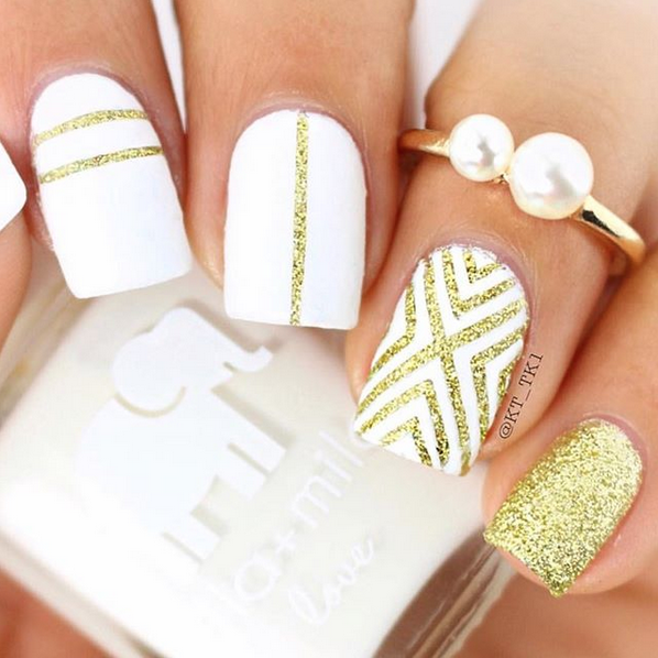 Golden Fairy gold glitter geometric accent nails over white with pearl ring