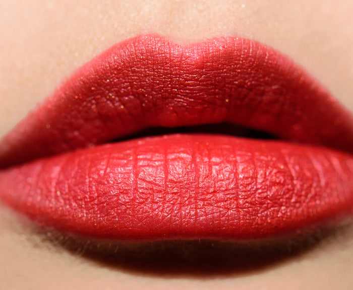 Guerlain Rouge G lipstick in exotic red shade with multiple caps, featuring a sleek, elegant beauty product image.
