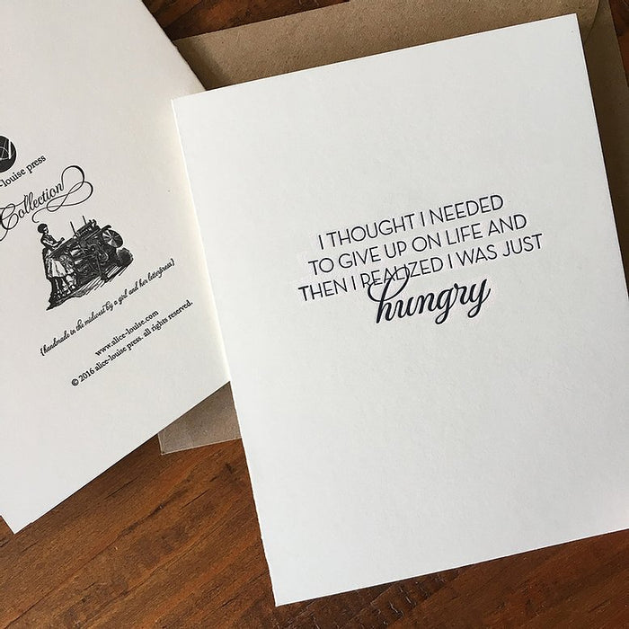 White quote greeting card with "hungry" script and inspirational text